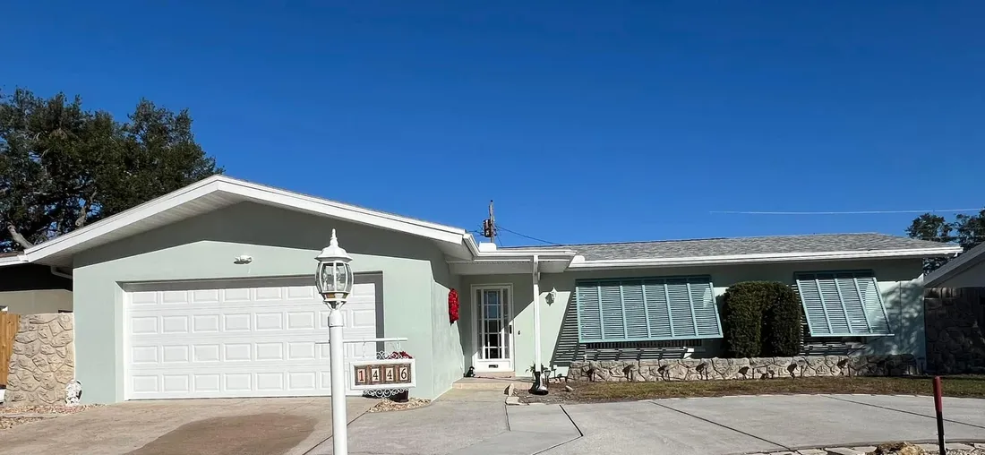 Repainted ranch home with whitewashed decorative stone and crisp white trim