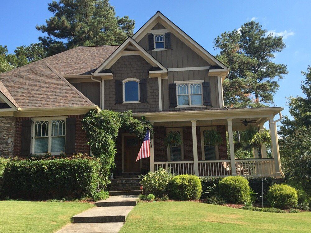 Two-story craftsman with a porch flag and a new roof