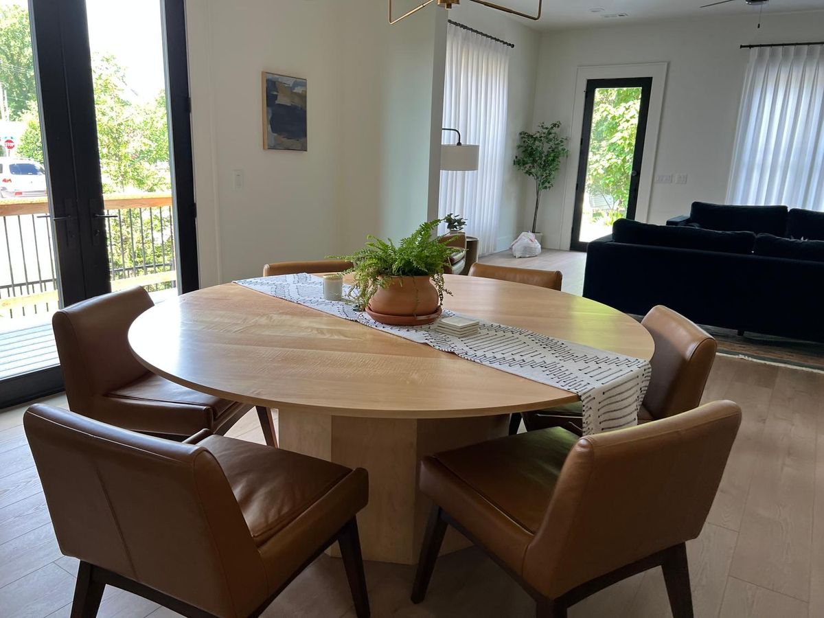 Dining table and chairs in a bright room after a clean