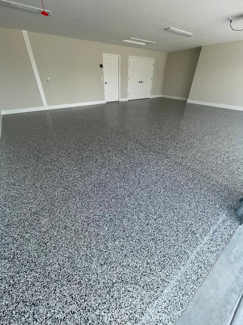 Gray full broadcast flake garage floor in a finished Central Florida garage