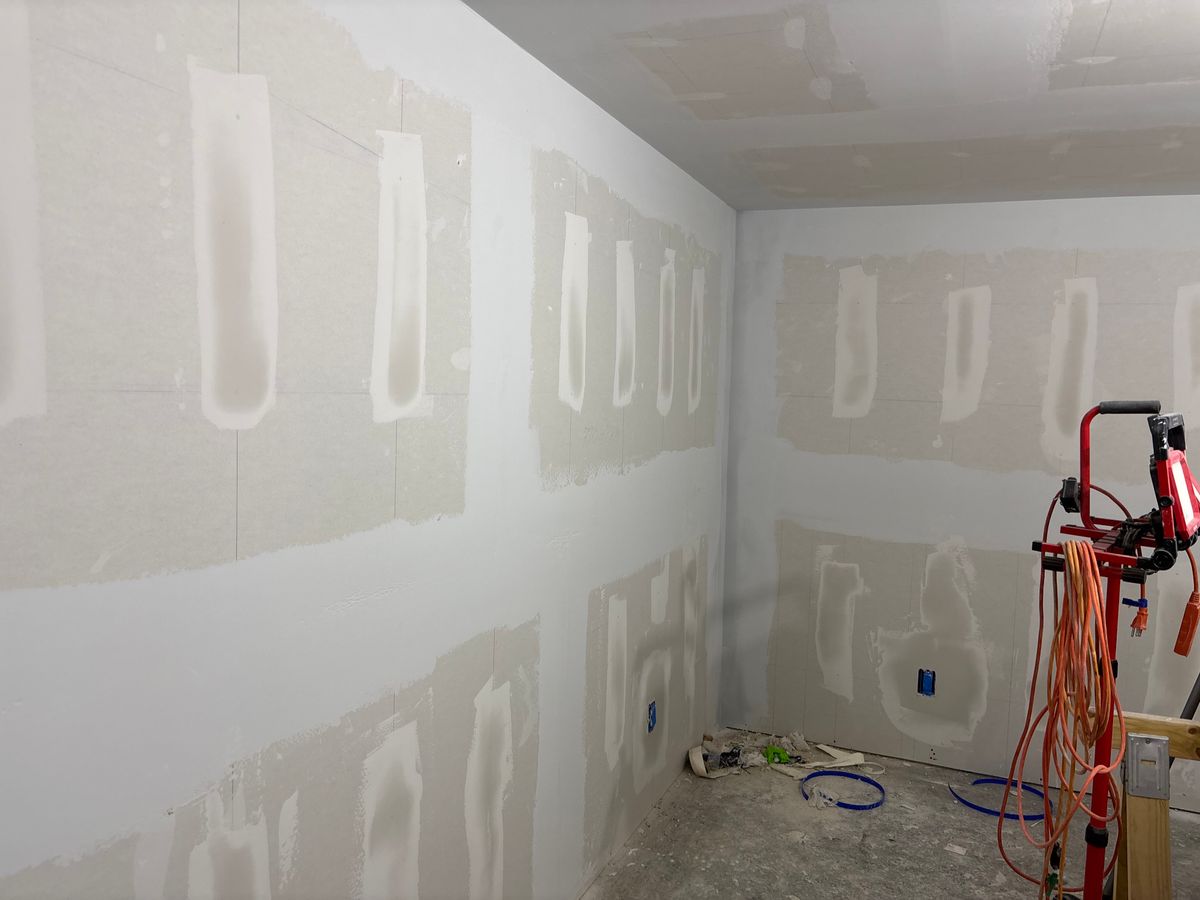 New sheetrock with mudded seams and a work light