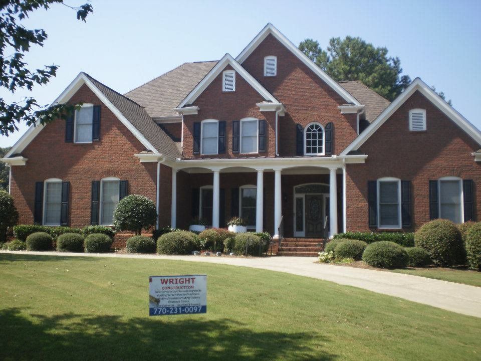 Brick colonial with a Wright Construction yard sign out front