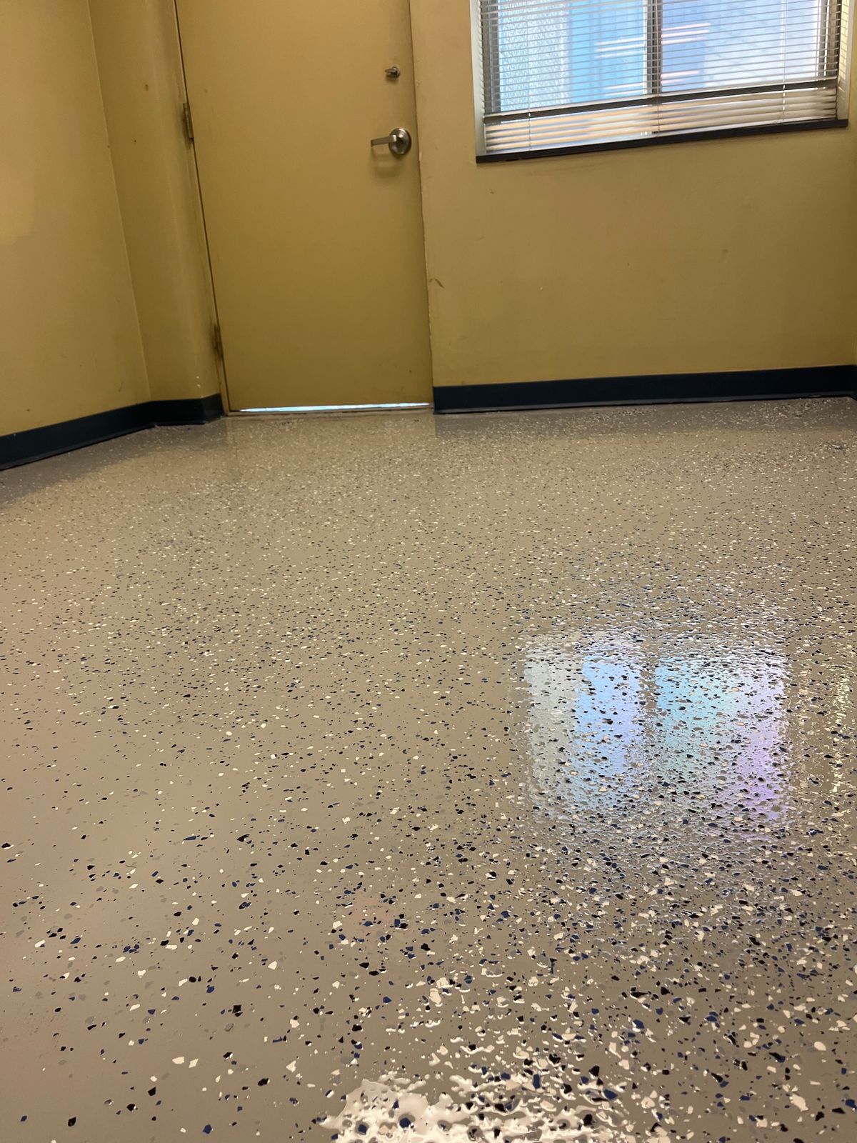 Close-up of a glossy flake epoxy floor