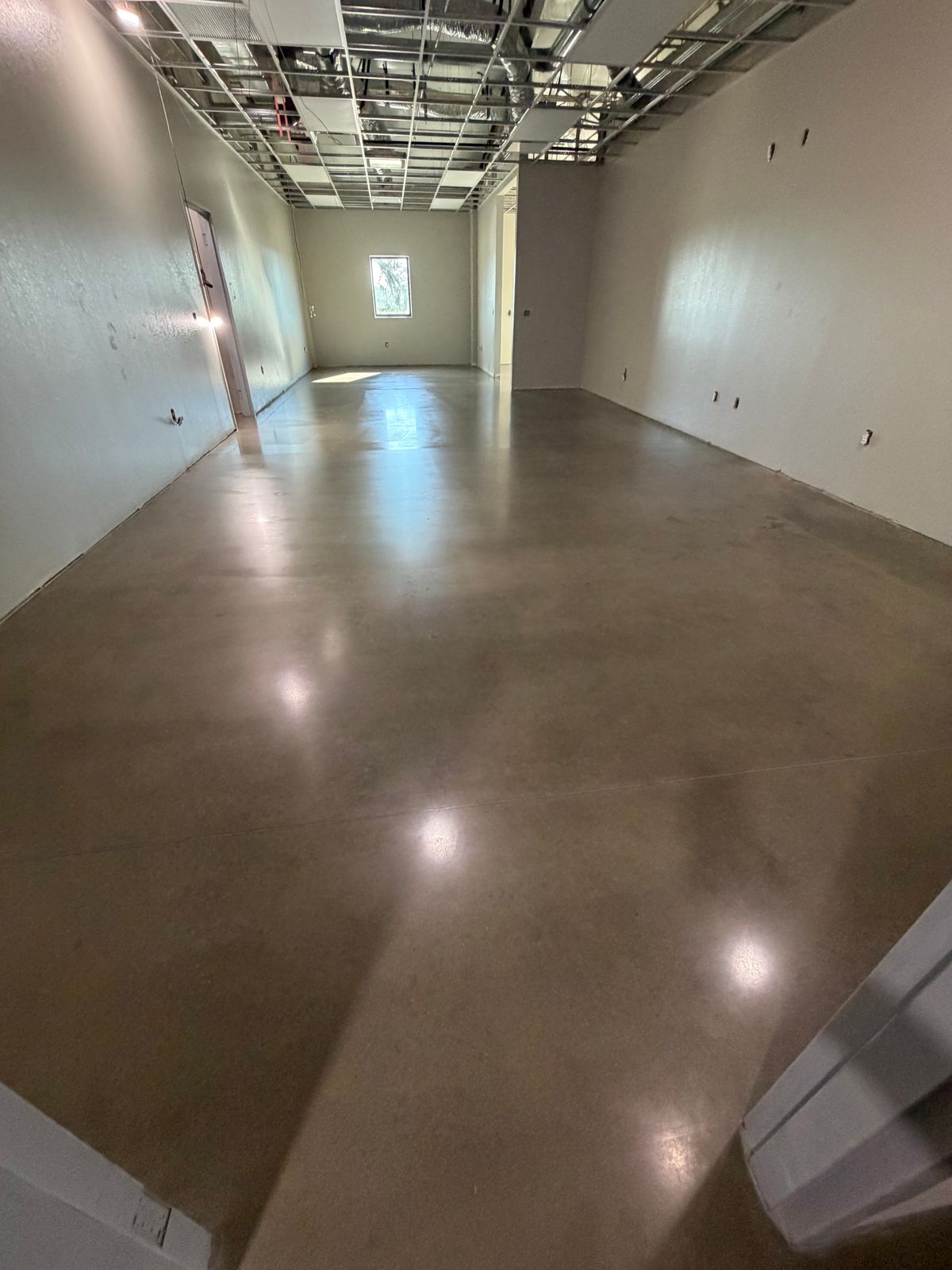 Polished concrete floor with a high sheen in an empty commercial space