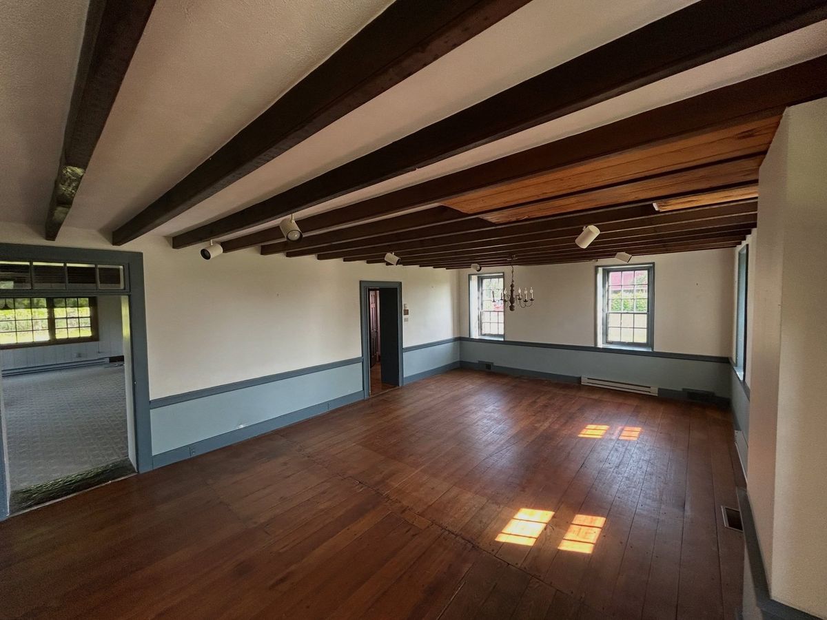 Wide view of a Roman Clay farmhouse room with beams