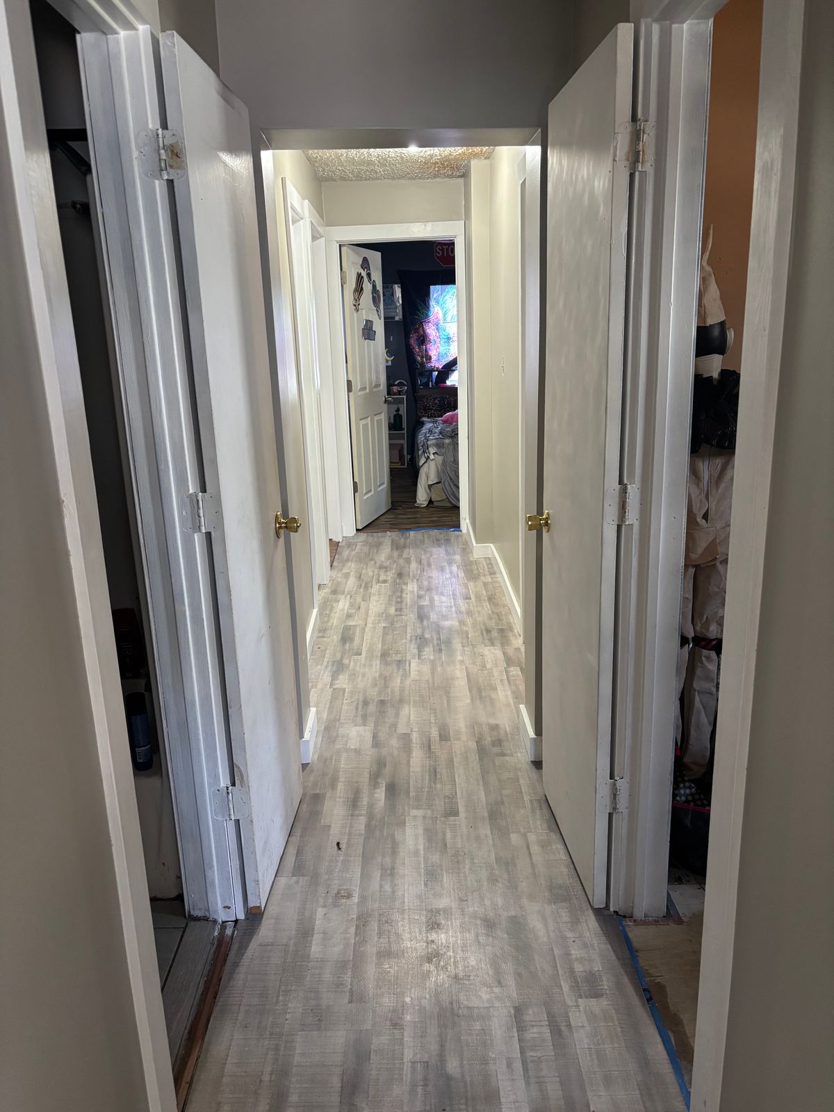Hallway with new plank flooring and white trim