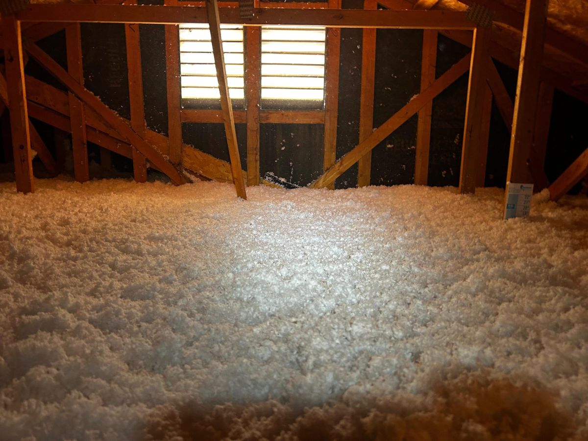 Finished Valley attic with deep blown-in insulation up to the gable vent