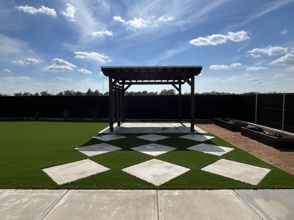 Checkerboard artificial turf and pavers under a pergola