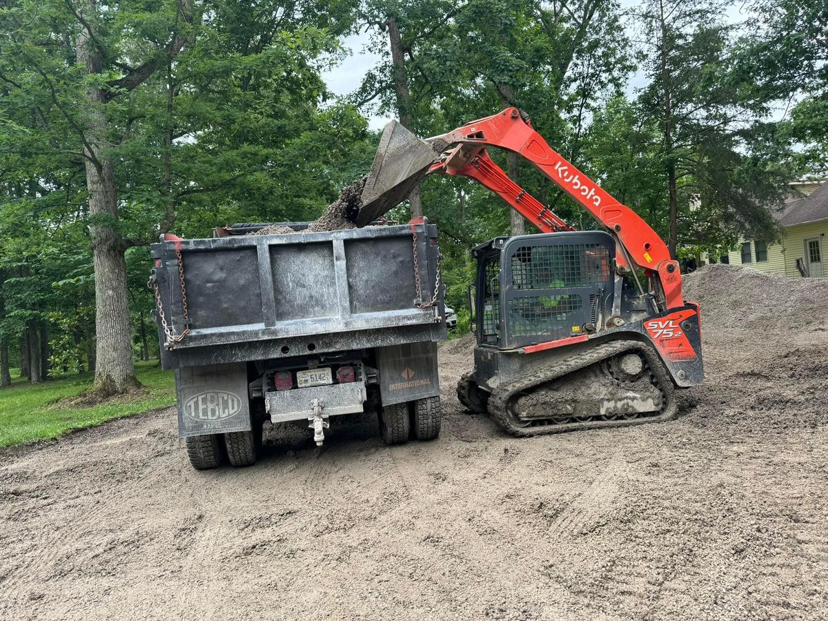 Hellard dump truck and skid steer on a job site