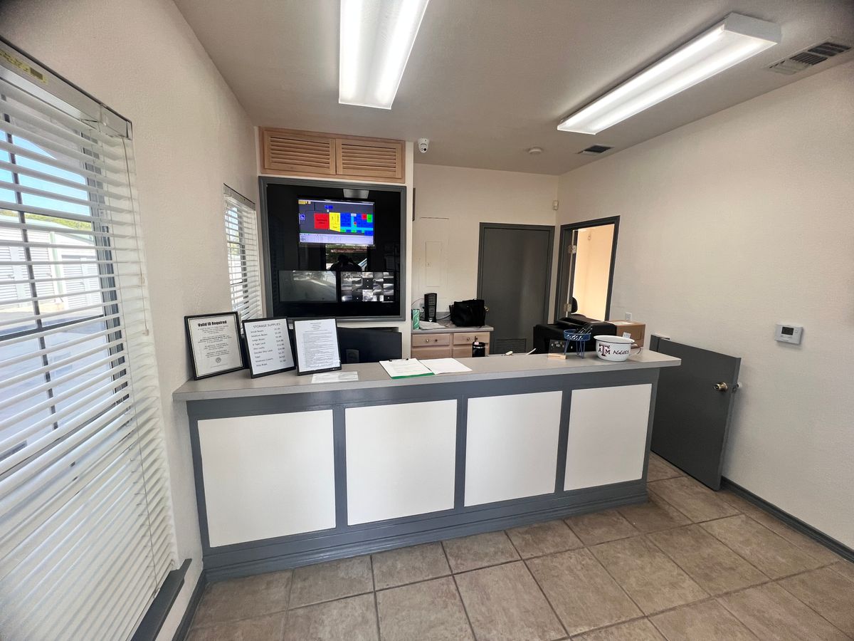 The same reception counter after repainting in white with grey trim