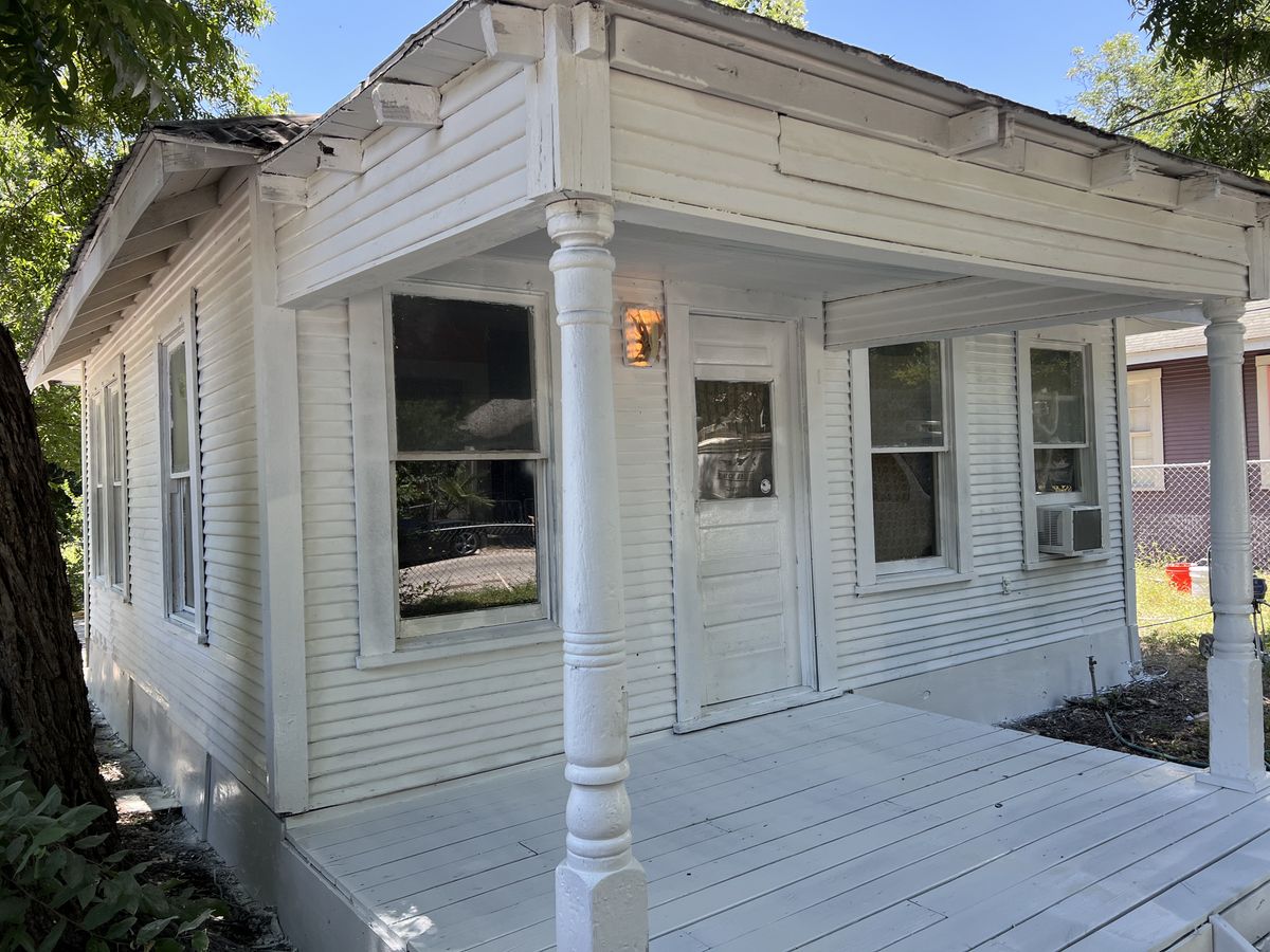 White clapboard house with a repainted columned front porch