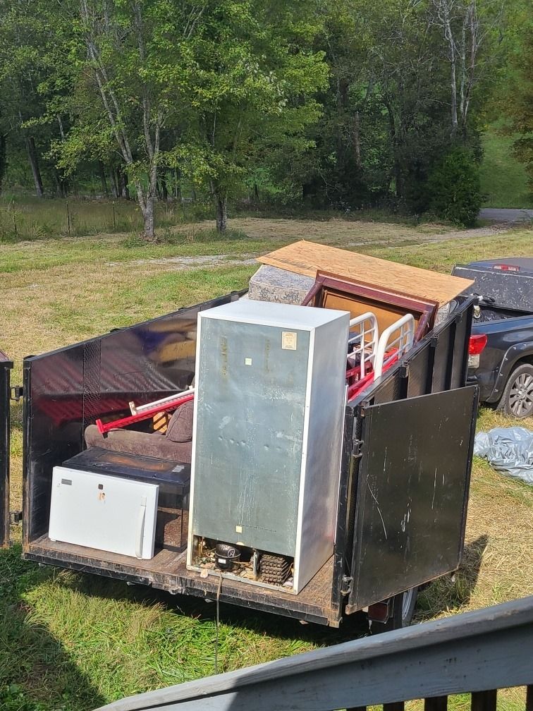 Trailer loaded with a refrigerator and household appliances in a Middle Tennessee yard