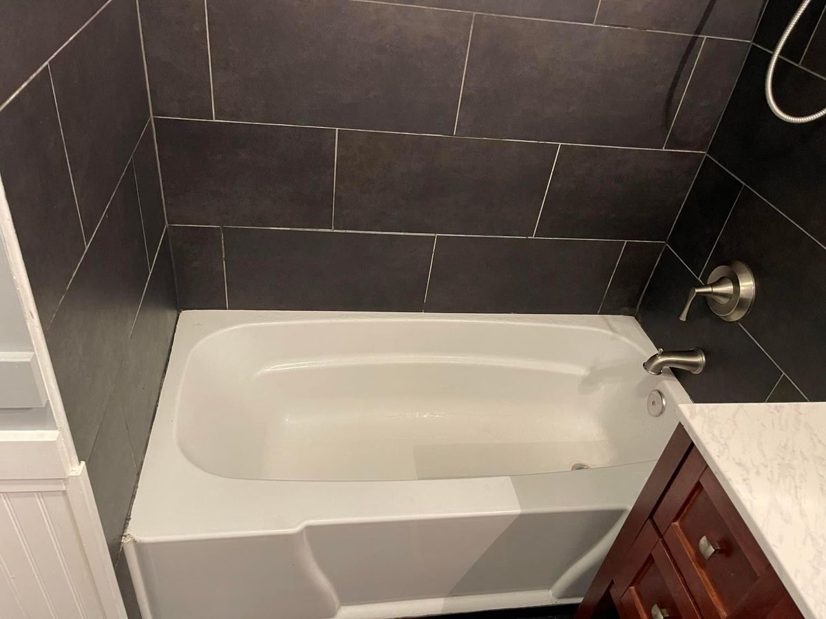 Finished bathroom tub with brushed nickel fixtures
