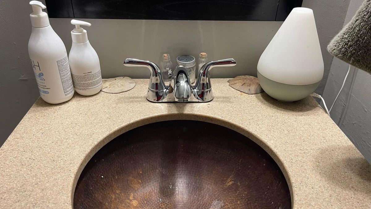 Bathroom vanity sink with a finished faucet and fixtures