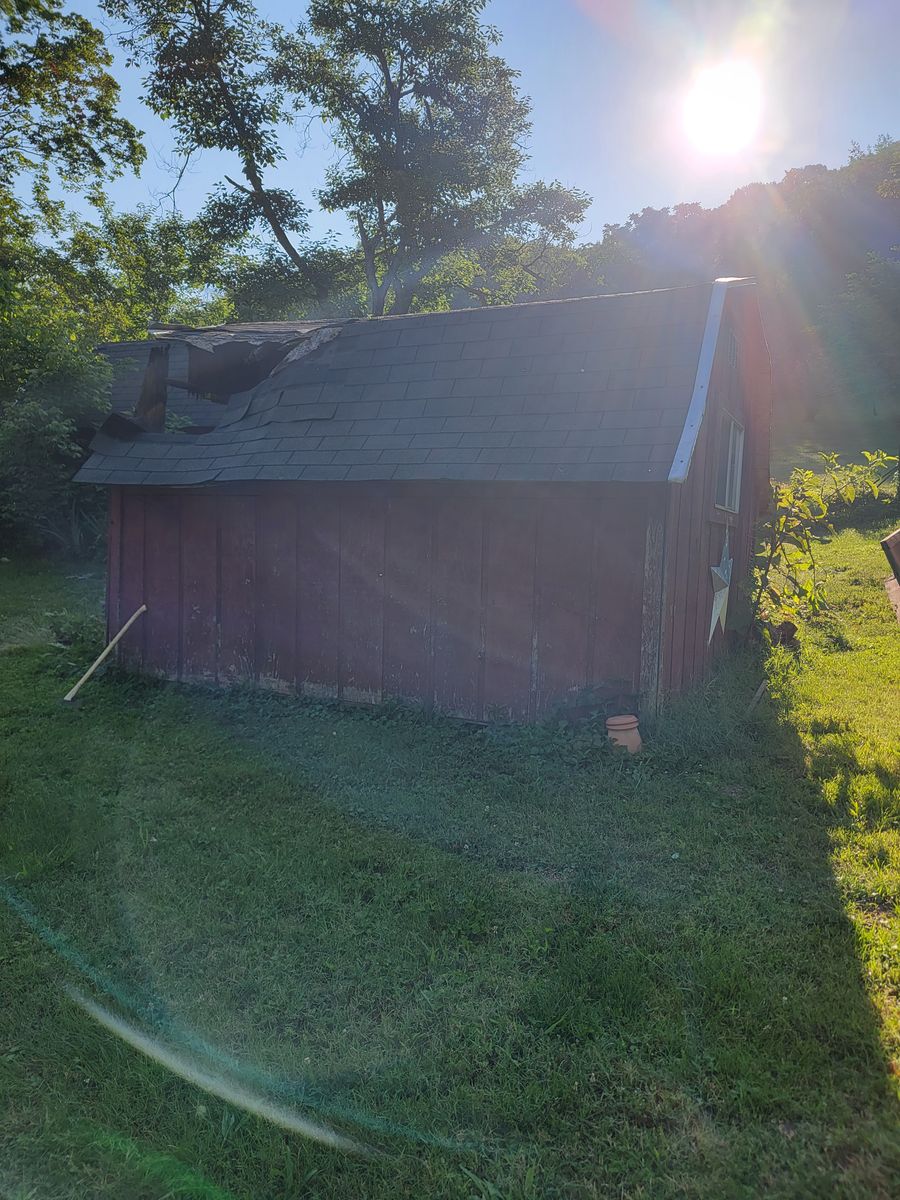 Red storage shed in the sun before teardown and haul-away