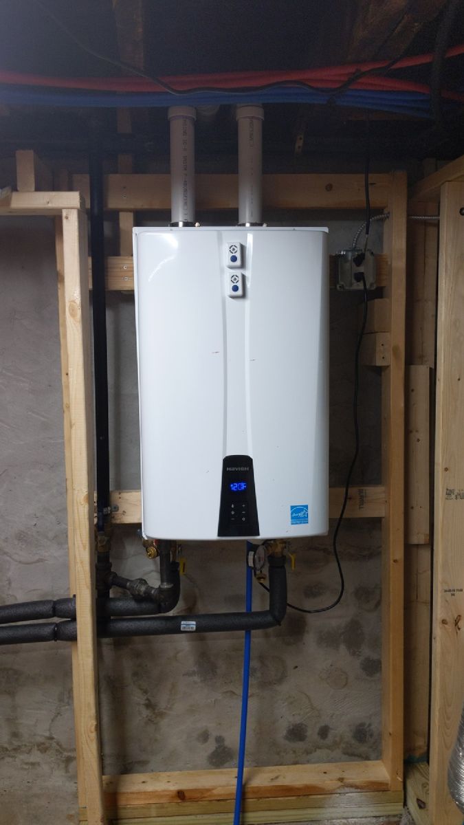 Tankless water heater mounted on new framing in a basement