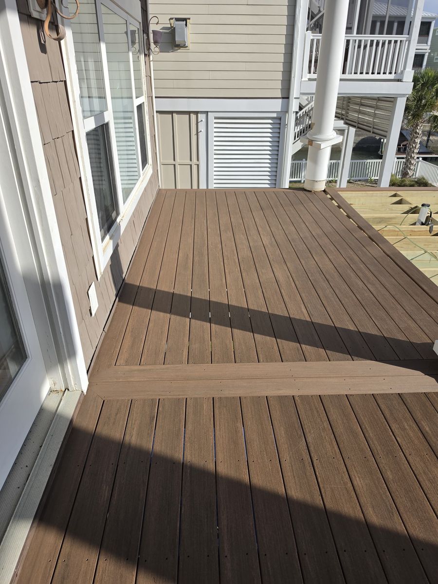 Dark stained wood deck with white rails