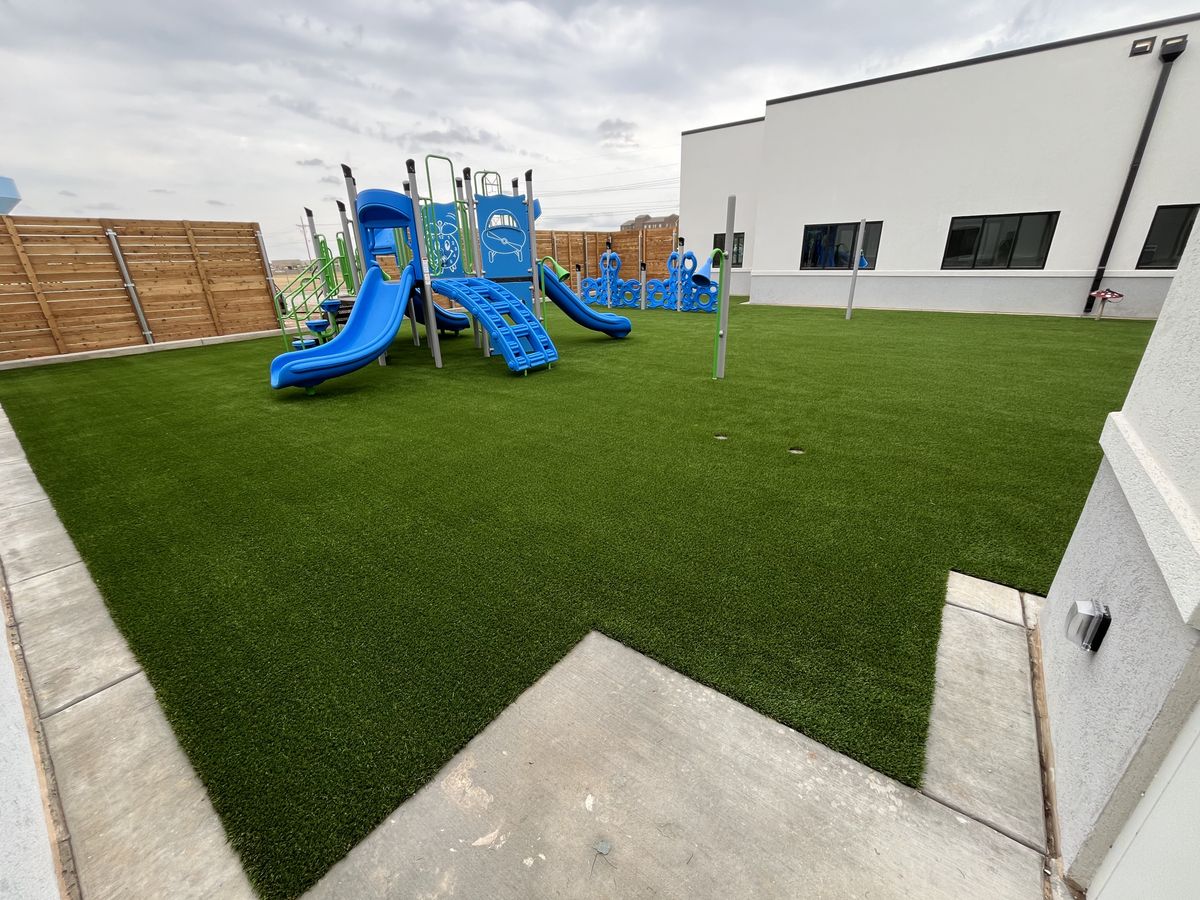 Artificial turf play area in a backyard