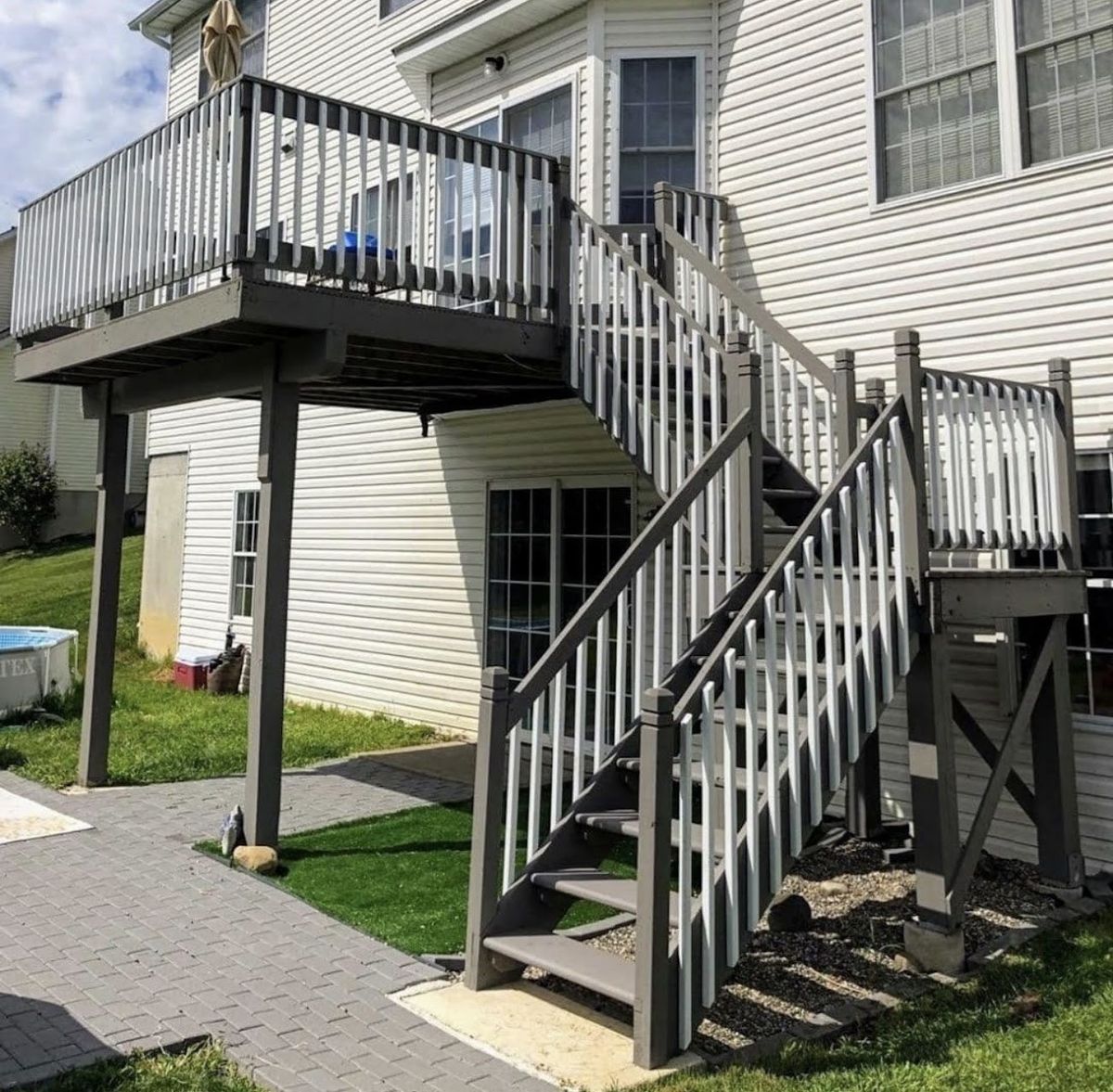The same deck stairs and railing after staining, finished in a rich gray-brown