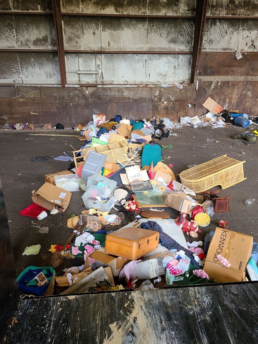 Top-down view of mixed household junk loaded in a trailer