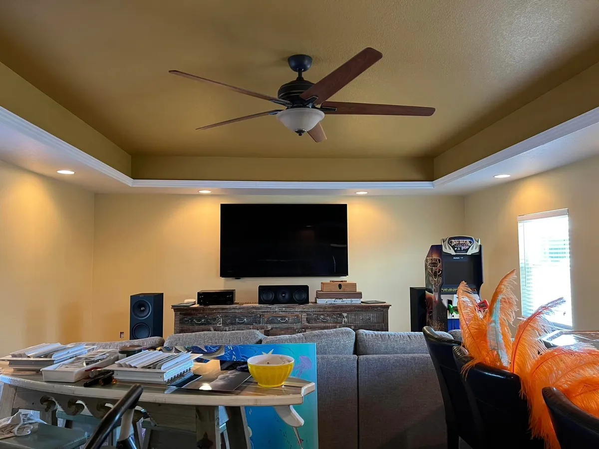 Living room before painting by Garrity Painting, showing a dated olive ceiling and worn walls