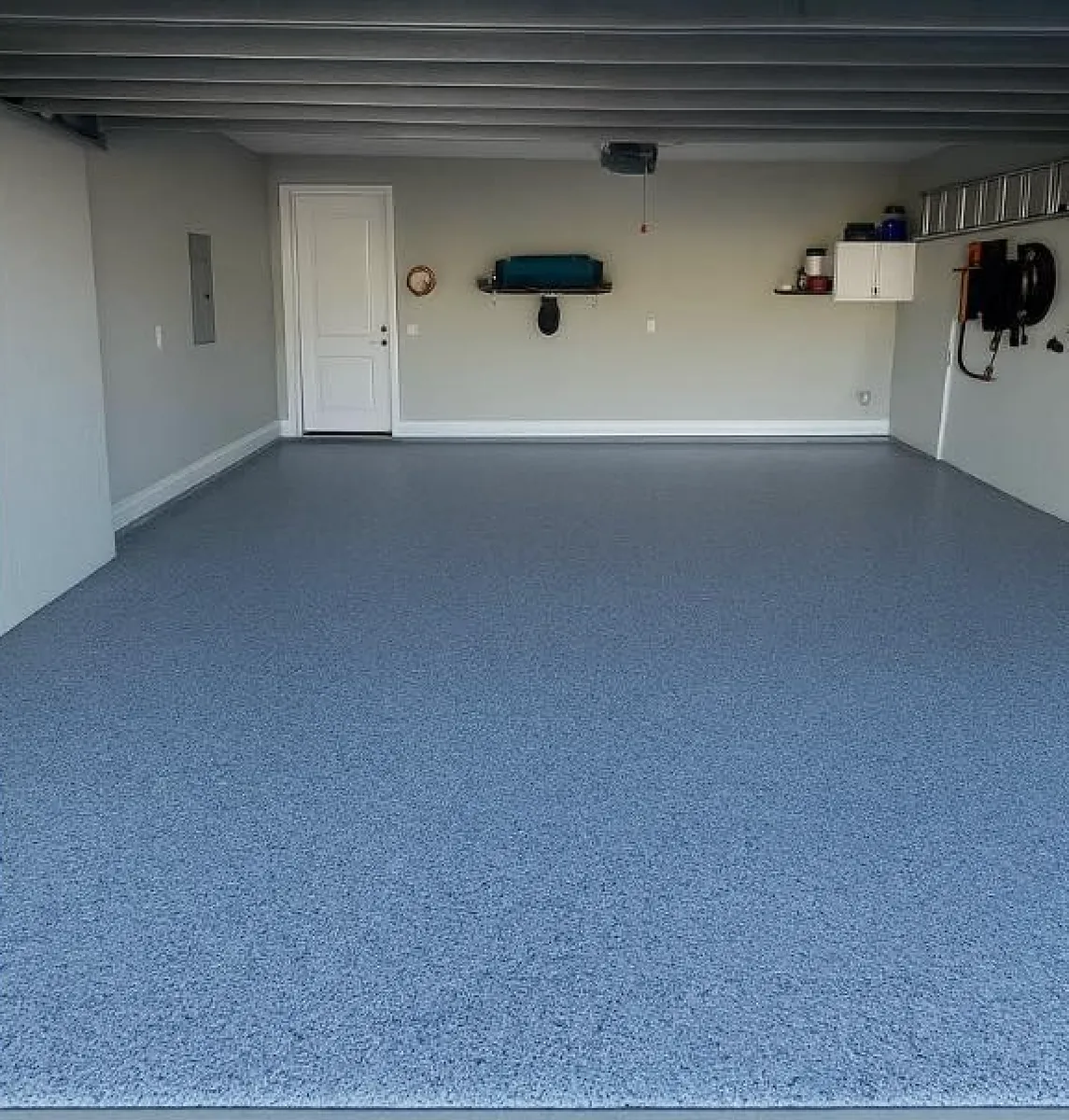 Epoxy garage floor coating with a gray and blue flake finish completed by Garrity Painting in Pinellas County
