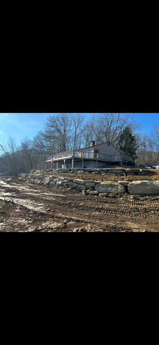 Machine set stone retaining walls for DArcy  Cleveland & Sons Excavation LLC in Pawcatuck, CT