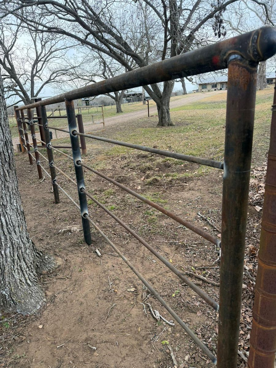 Custom Pipe fencing, entrances and riding arena for Landers Ranch Services in Grimes County, TX