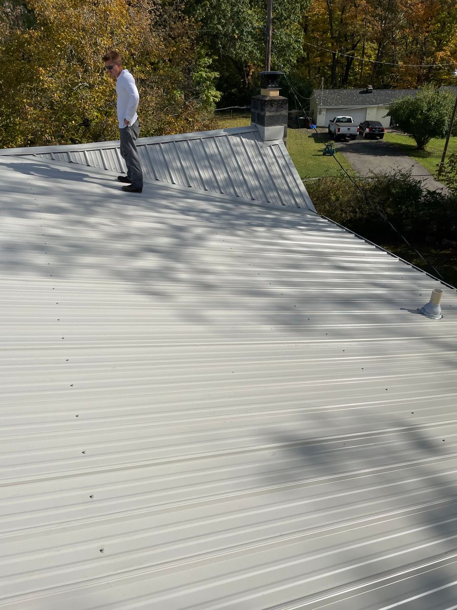 Metal roof installation for Precious Roofing in Madeira, OH