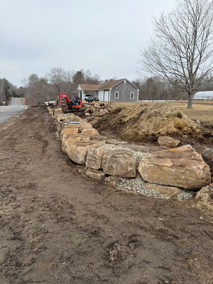 Machine set stone retaining walls for DArcy  Cleveland & Sons Excavation LLC in Pawcatuck, CT