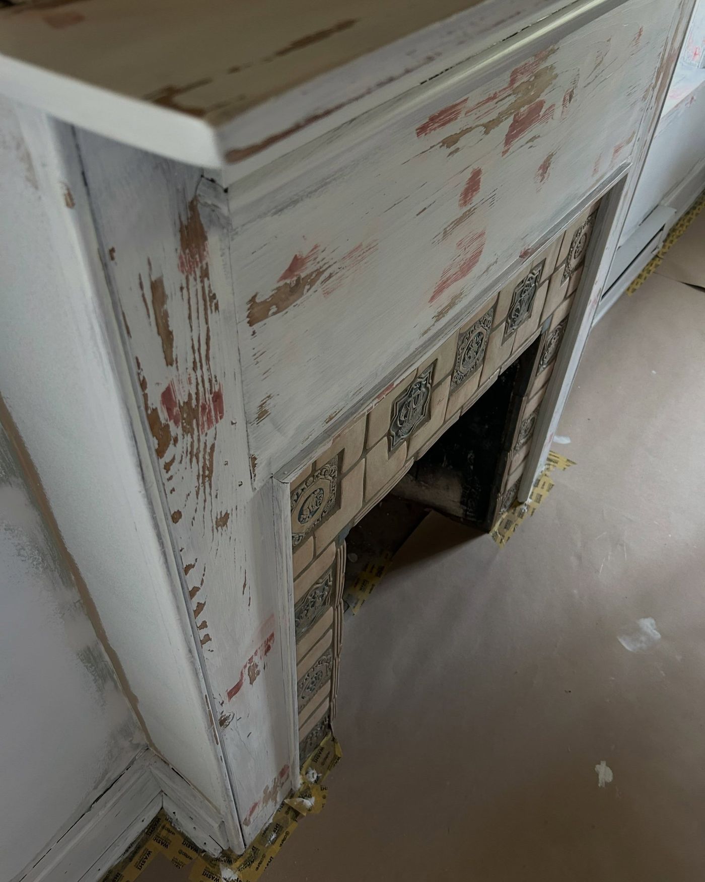 Old fireplace surround stripped and patched before painting