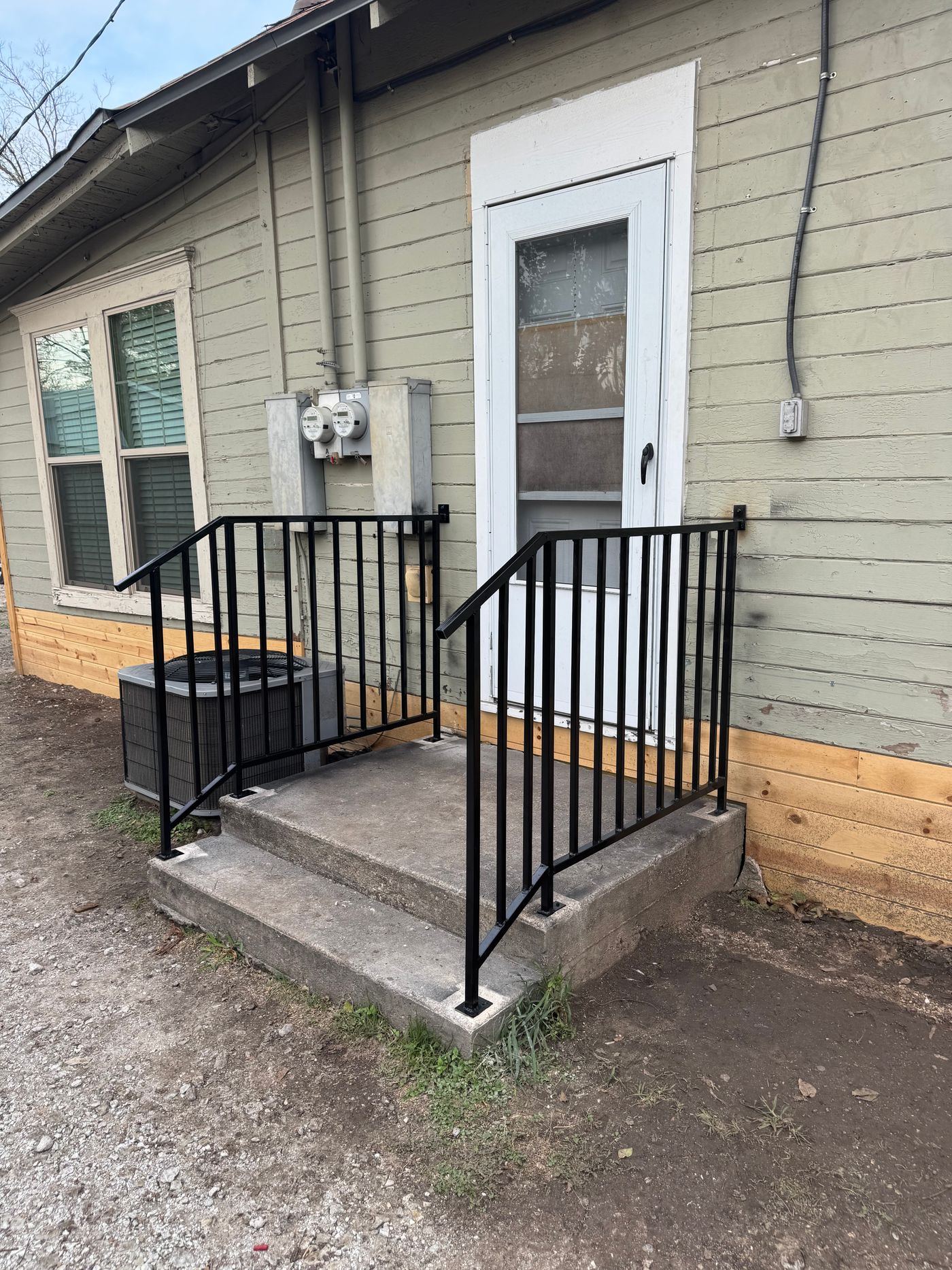 Welded iron stair rails, set in concrete