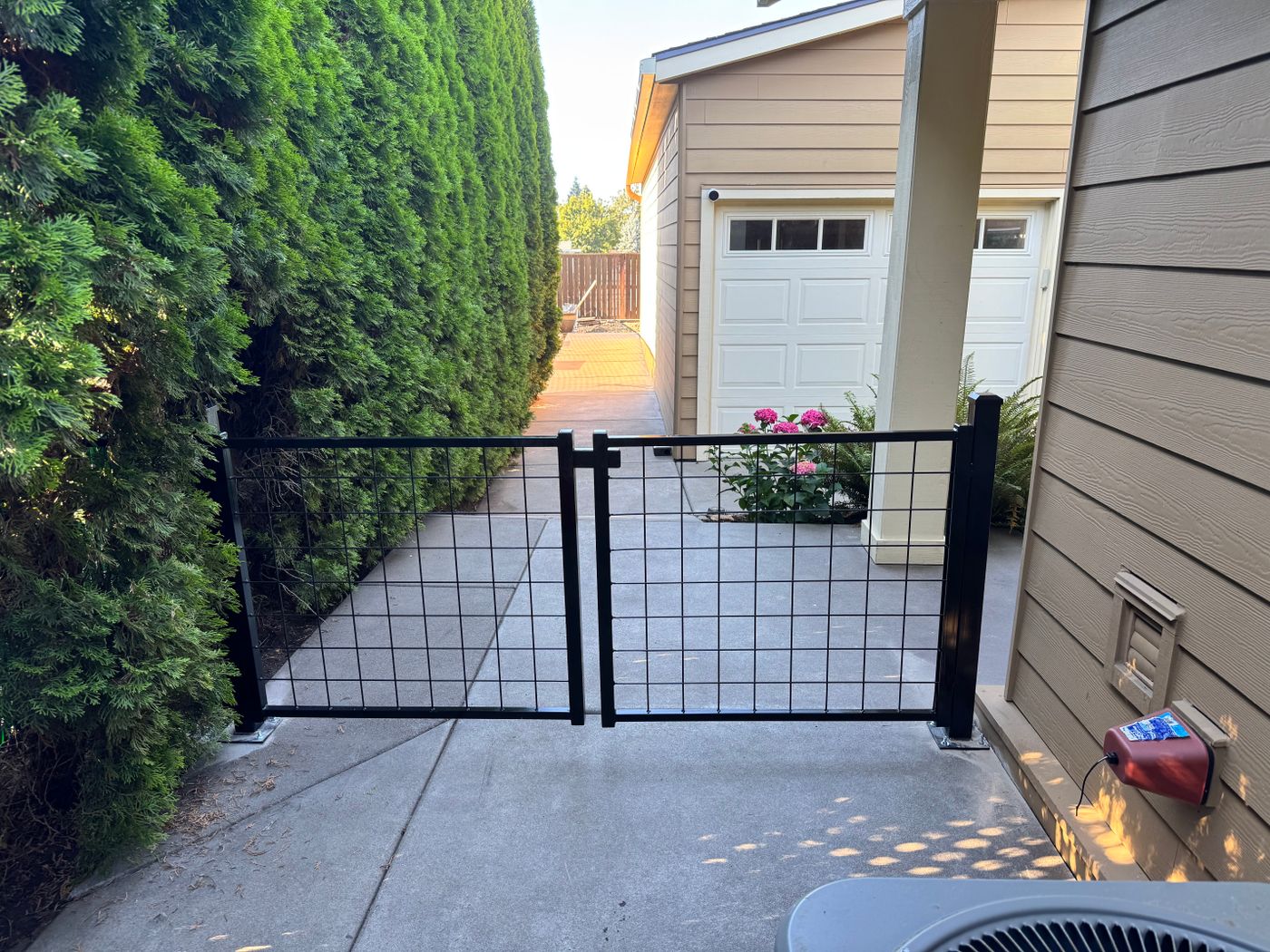 Black wire-grid double gate at a house