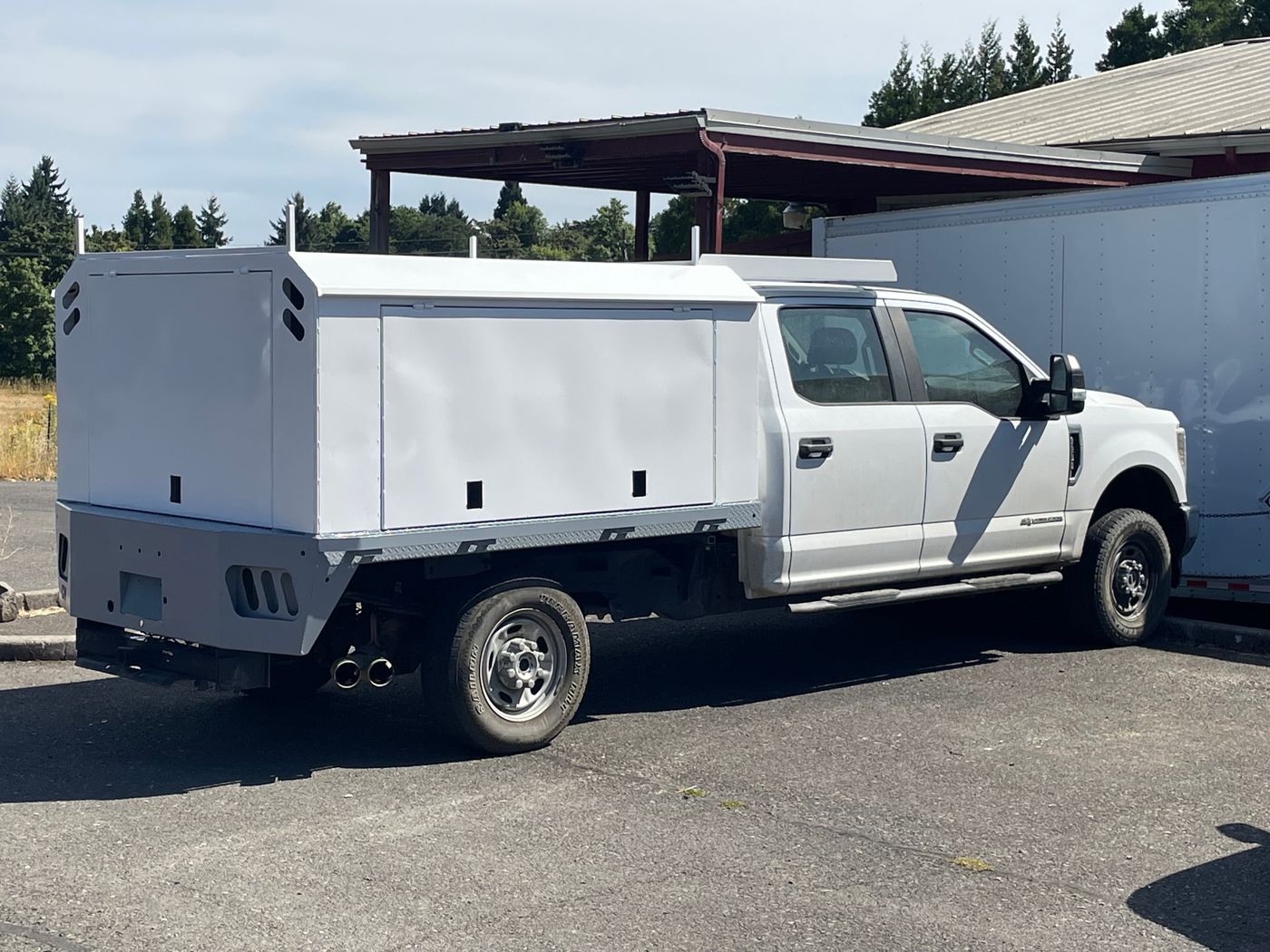 White Ford pickup with a custom aluminum service body built by Valhalla Welding