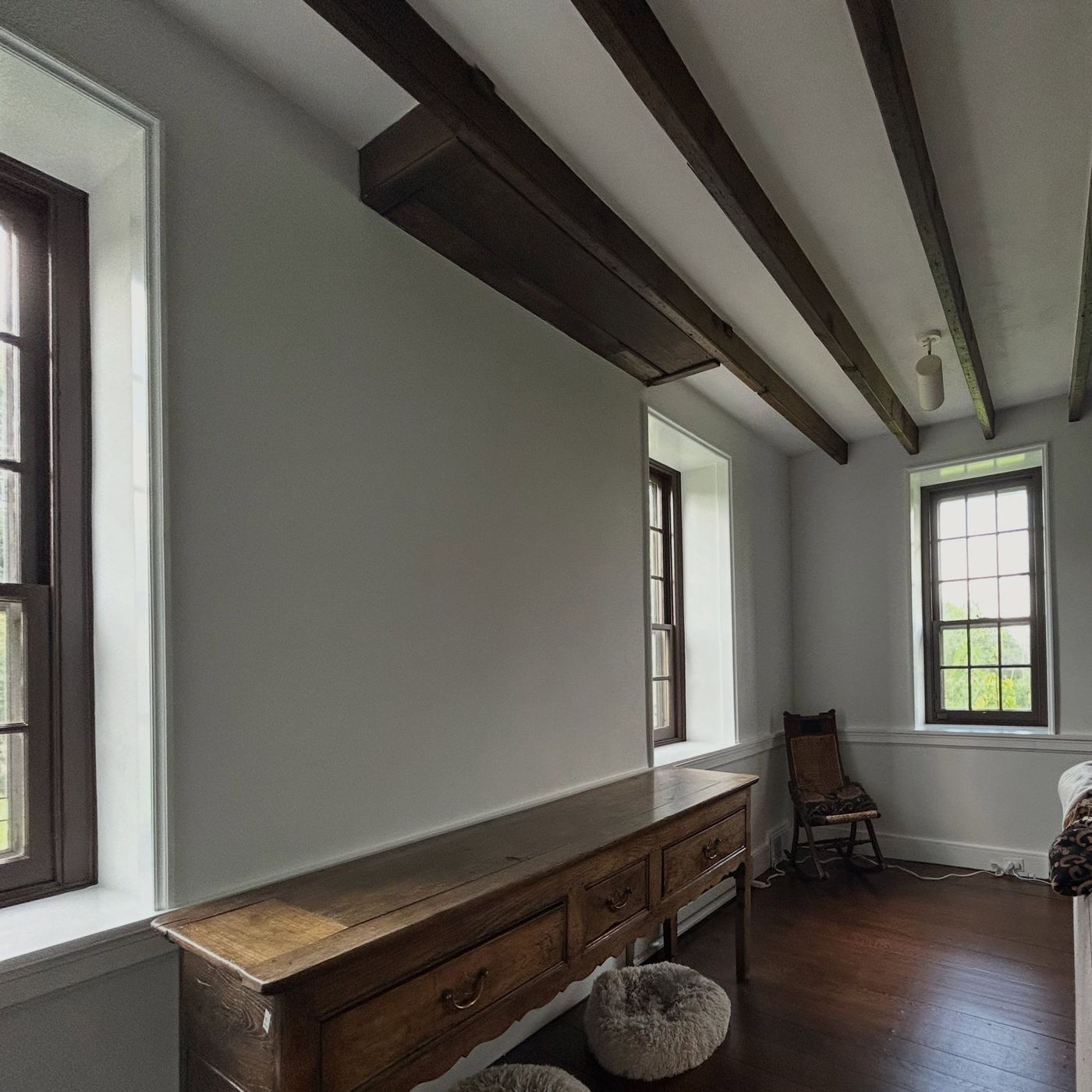Farmhouse room with Roman Clay walls, dark beams and restored windows