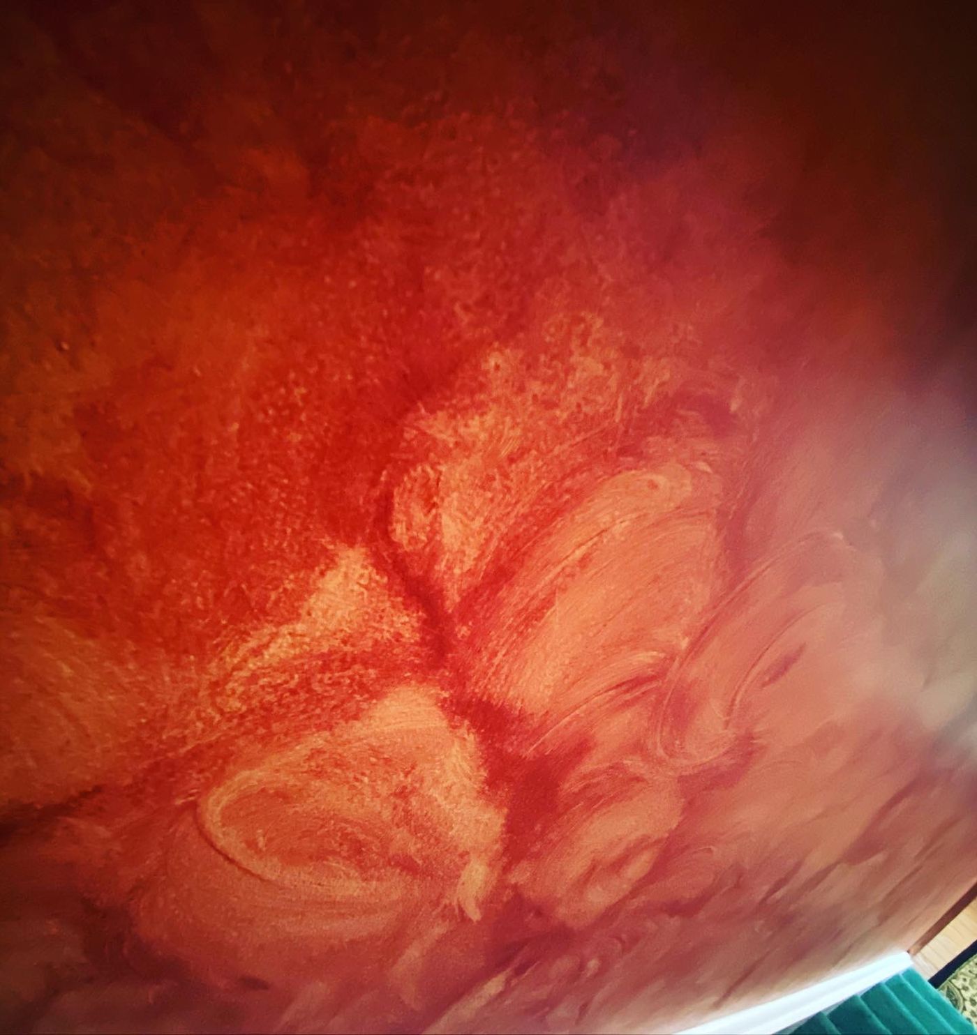 Red Venetian plaster wall with polished movement
