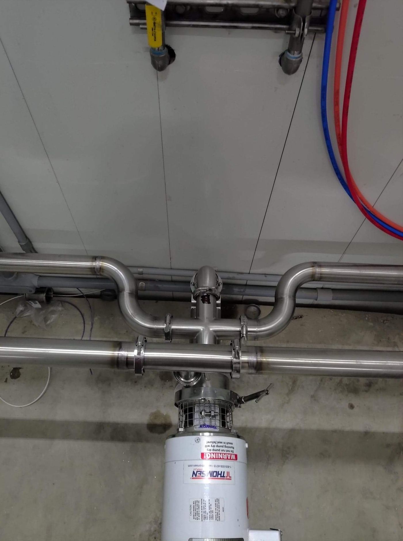 Stainless Tri-Clamp product line over a dairy pump