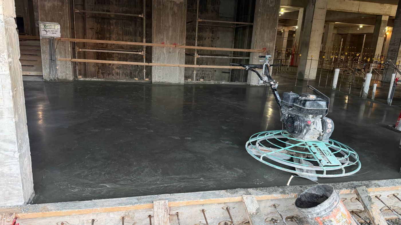 Crew placing concrete over a reinforced mat with a boom pump