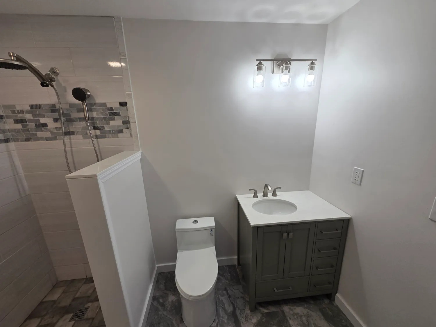Finished bathroom remodel with new vanity, lighting and tile