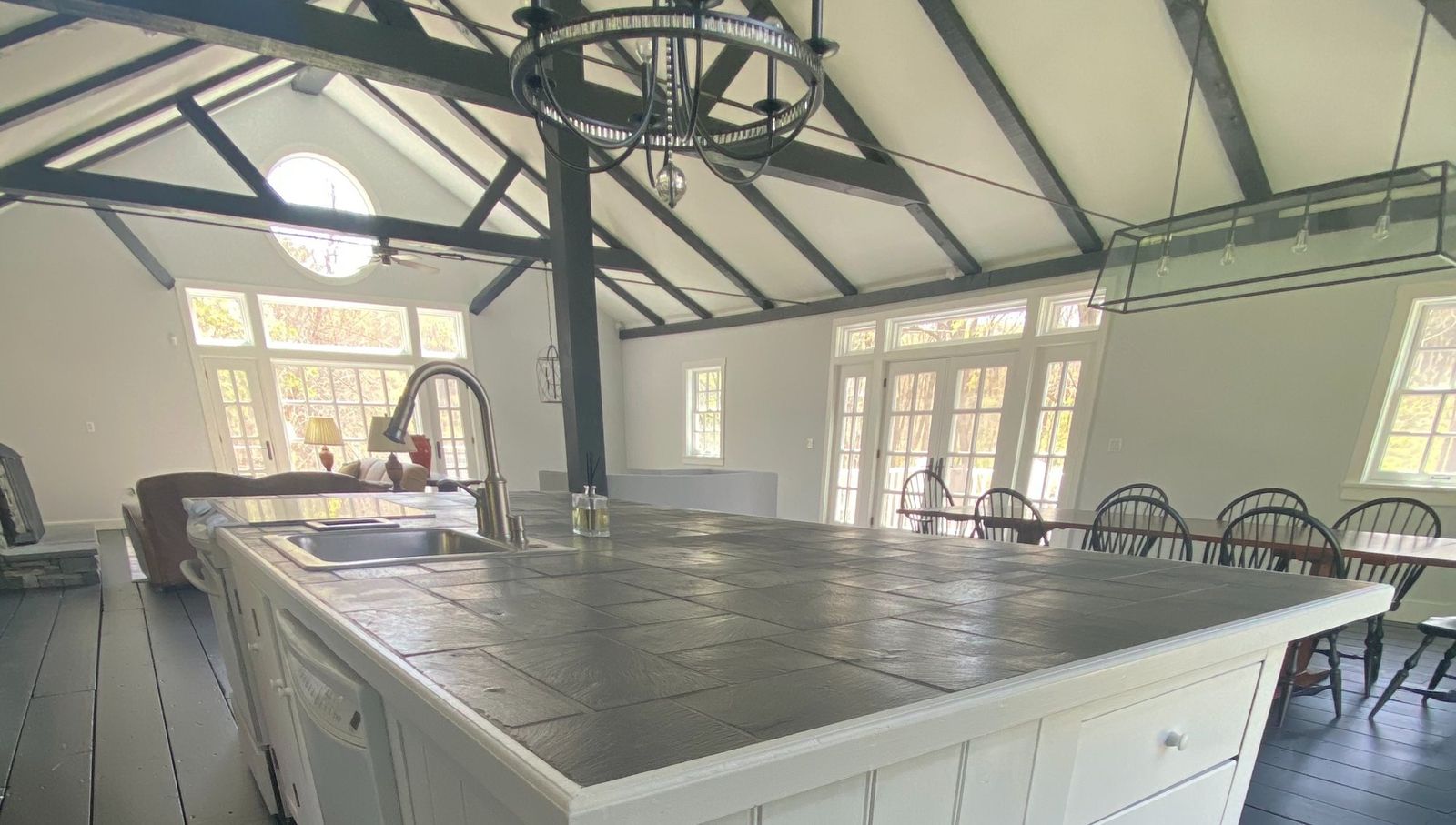 Converted barn interior with black beams and white walls
