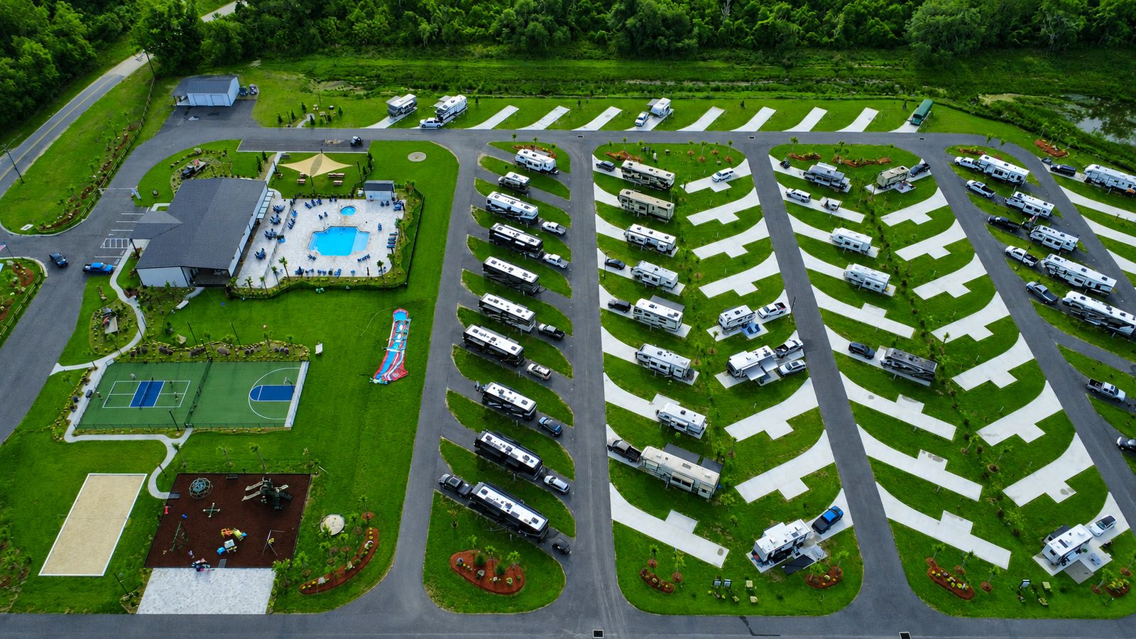 Aerial view of Heritage Oaks RV Resort showing the pool, clubhouse, sport courts and rows of level RV sites