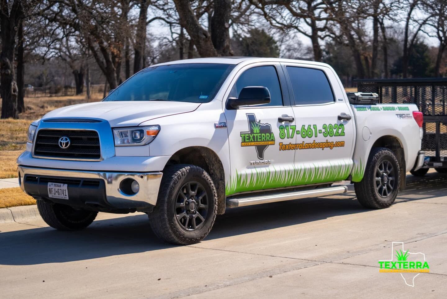White Texterra Lawn & Landscaping Toyota Tundra with the company phone number on the door
