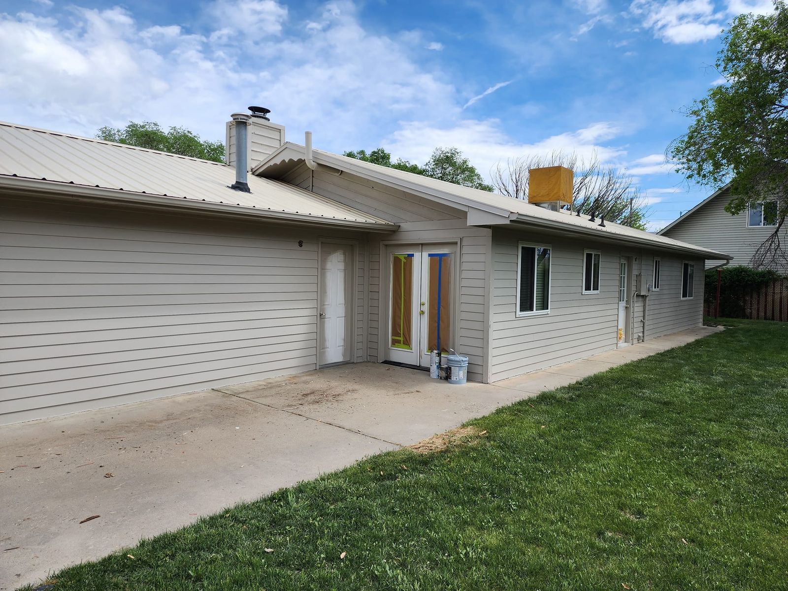 Long ranch home in the Grand Valley with new lap siding and a metal roof