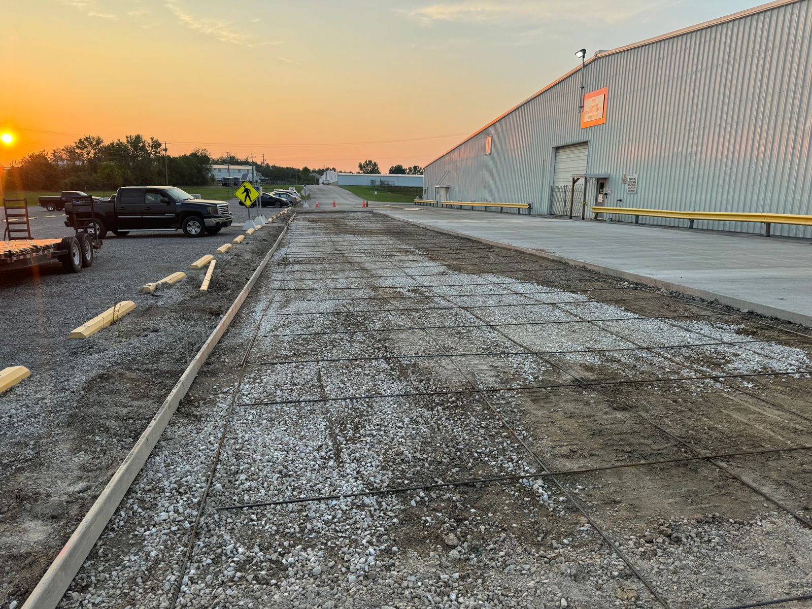 Warehouse apron at sunset after a commercial concrete pour