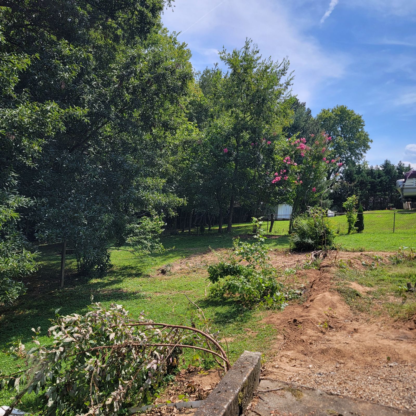 Cleared yard beside a house after debris removal in Spring Hill, TN