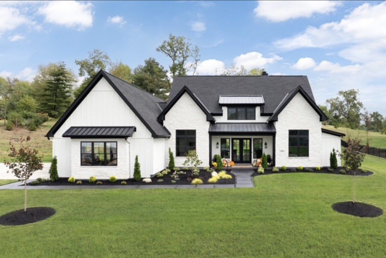 White modern farmhouse with black trim and a freshly finished exterior near Cincinnati