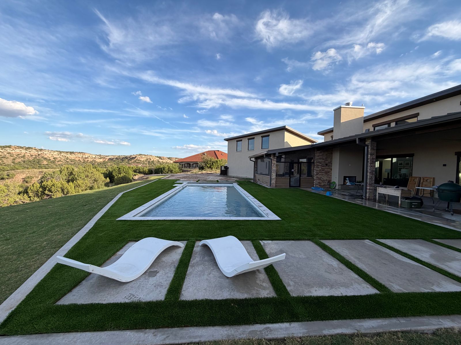 Artificial turf with lounge chairs overlooking a canyon view at an Amarillo area home