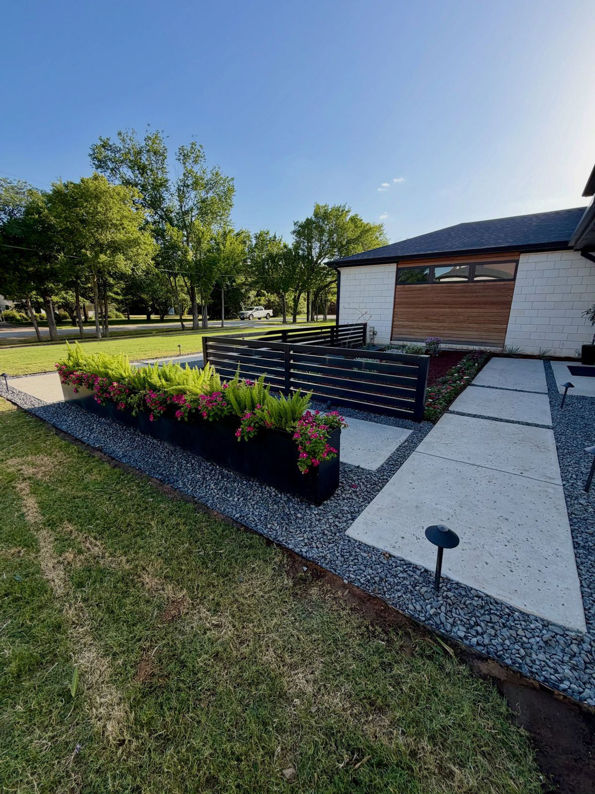 Modern front yard walk with gravel joints and new mulch beds