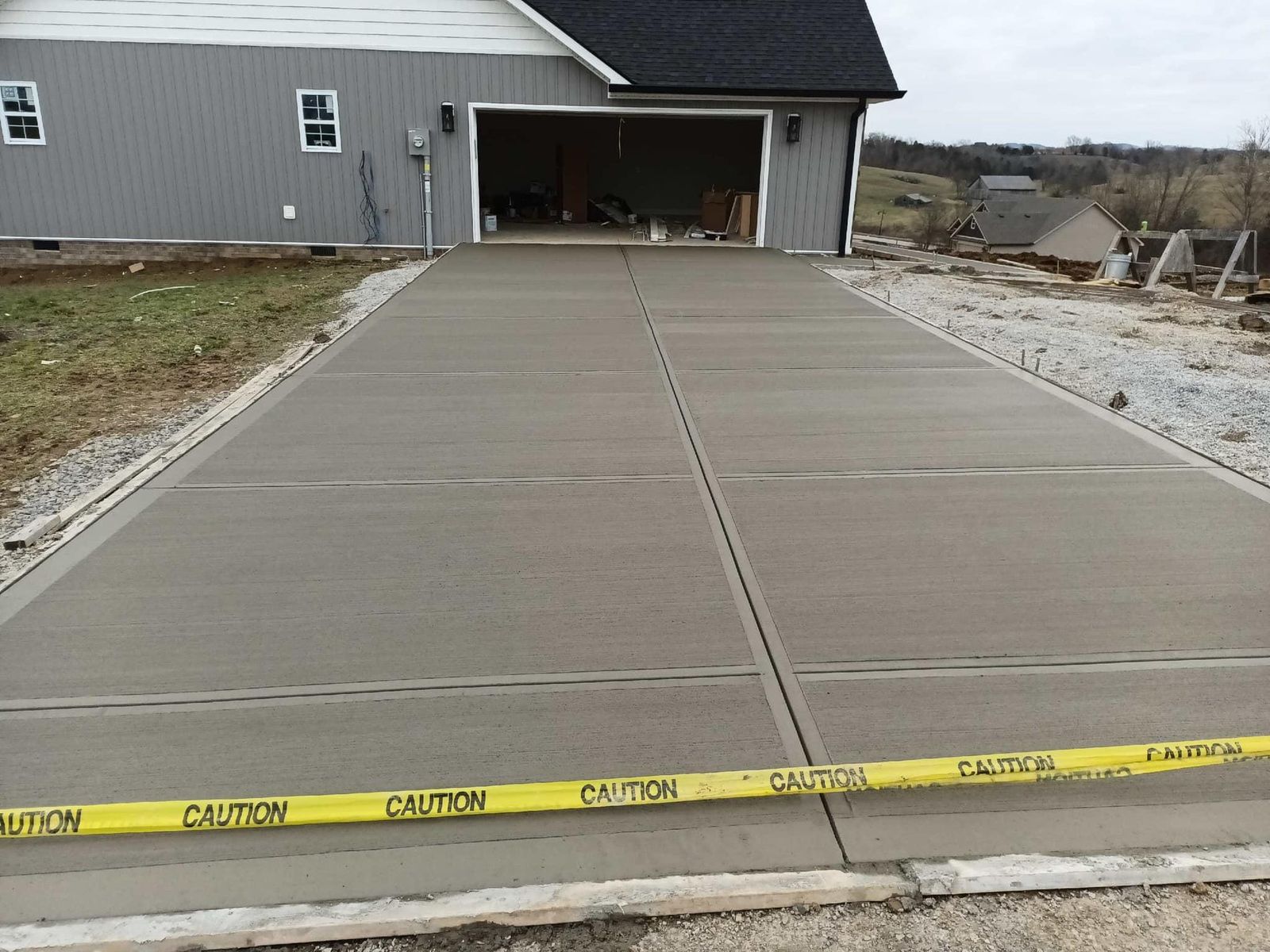 Concrete driveway poured up to a home garage