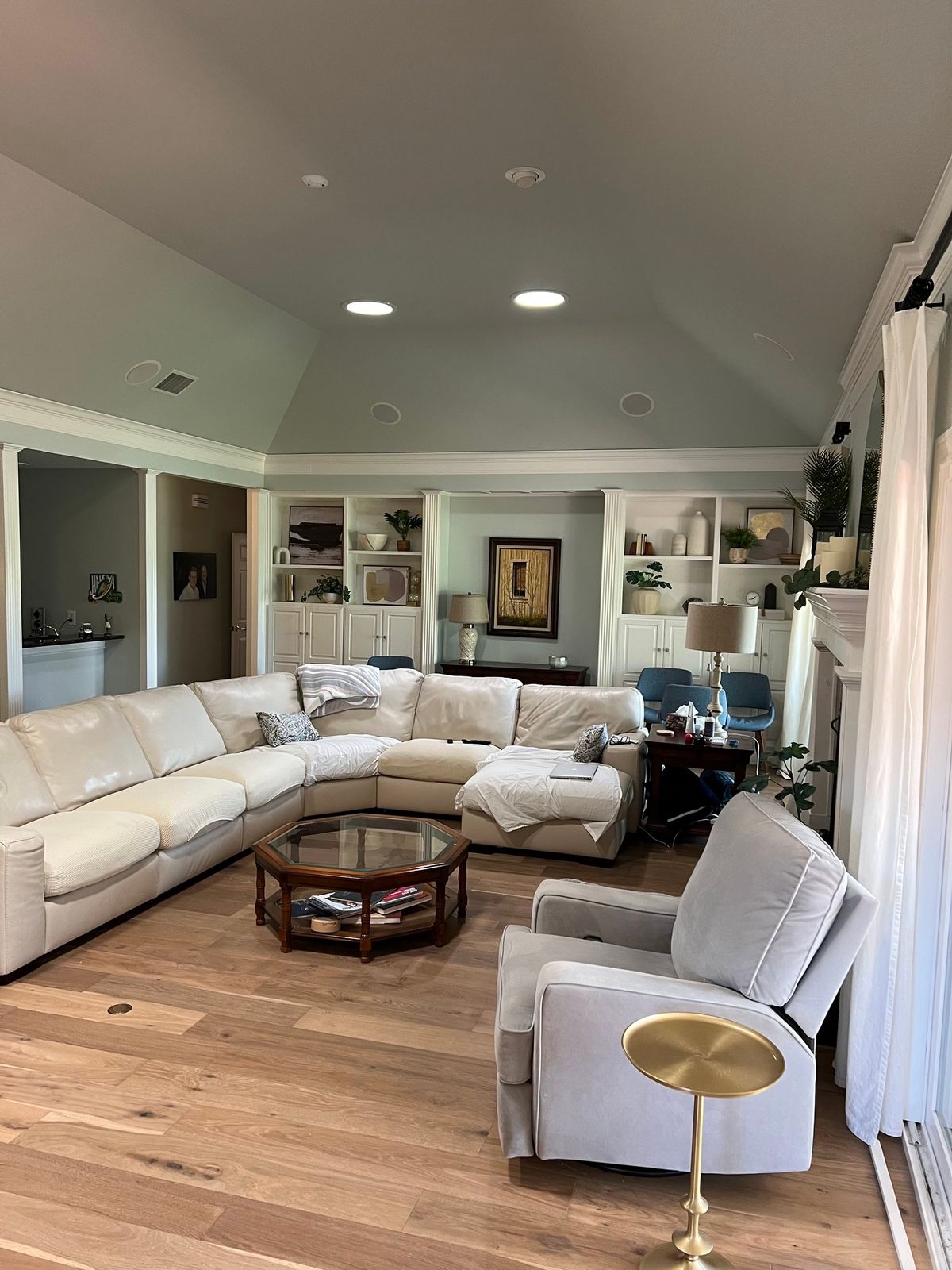 Living room with painted built in shelving either side of the fireplace